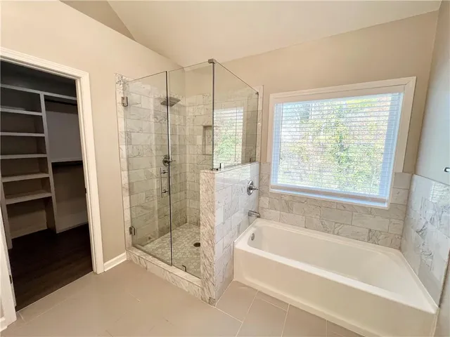 a spacious bathroom with a granite countertop sink a toilet and a mirror