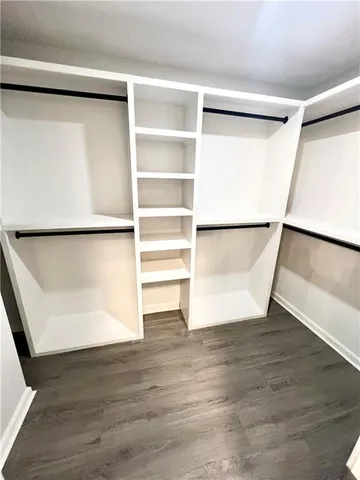 a bath tub sitting next to a white toilet and a shower