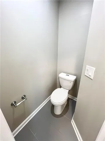 a kitchen with stainless steel appliances wooden floors and white walls