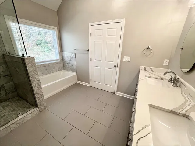 a bathroom with a granite countertop sink mirror vanity and toilet