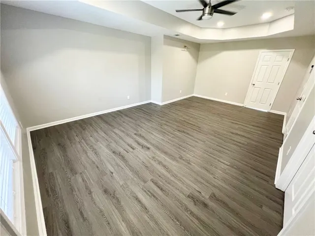 wooden floor in an empty room with a window
