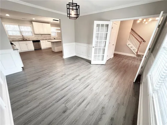 wooden floor in an empty room with a mirror