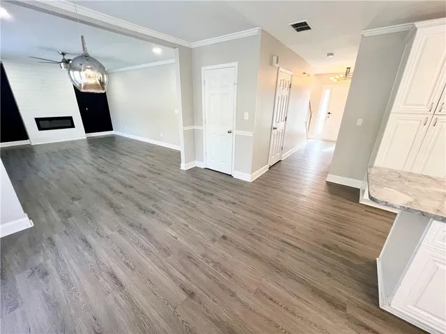 a view of a hallway with wooden floor and staircase