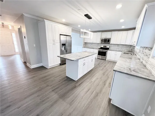 a white toilet sitting next to a shower