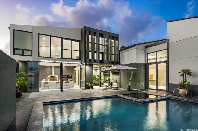 a living room with furniture a flat screen tv and a floor to ceiling window