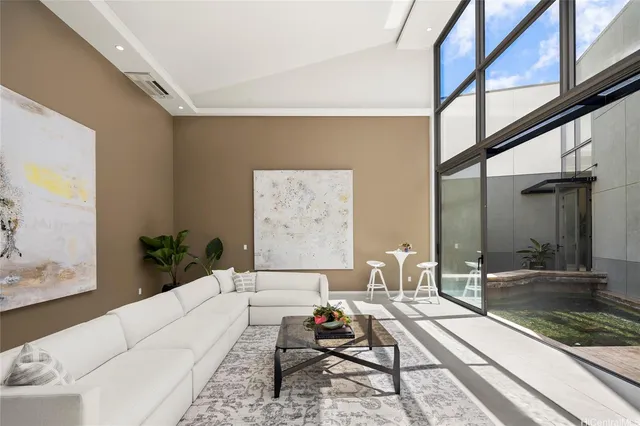 a living room with furniture and a floor to ceiling window