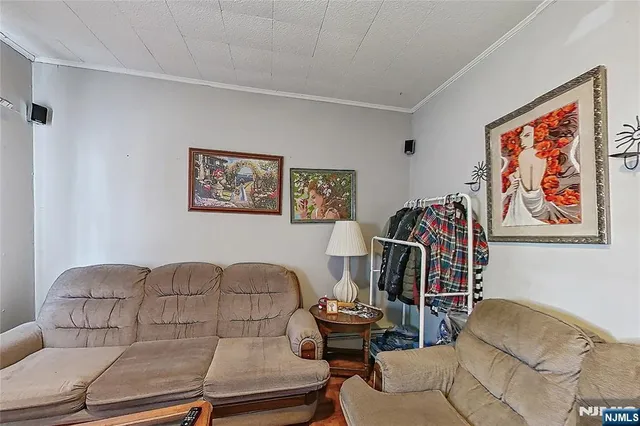 a living room with furniture a couch and paintings on the wall