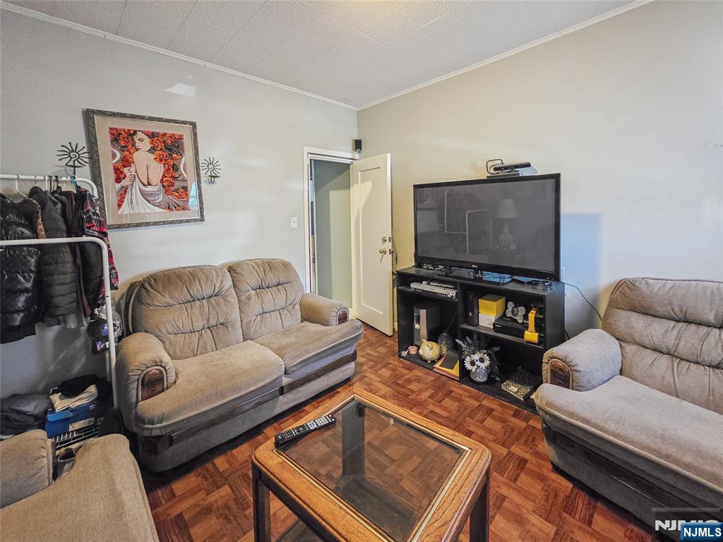 42 Grand Street Garfield, NJ 07026 - Photo 13 of 26 a living room with furniture and a flat screen tv