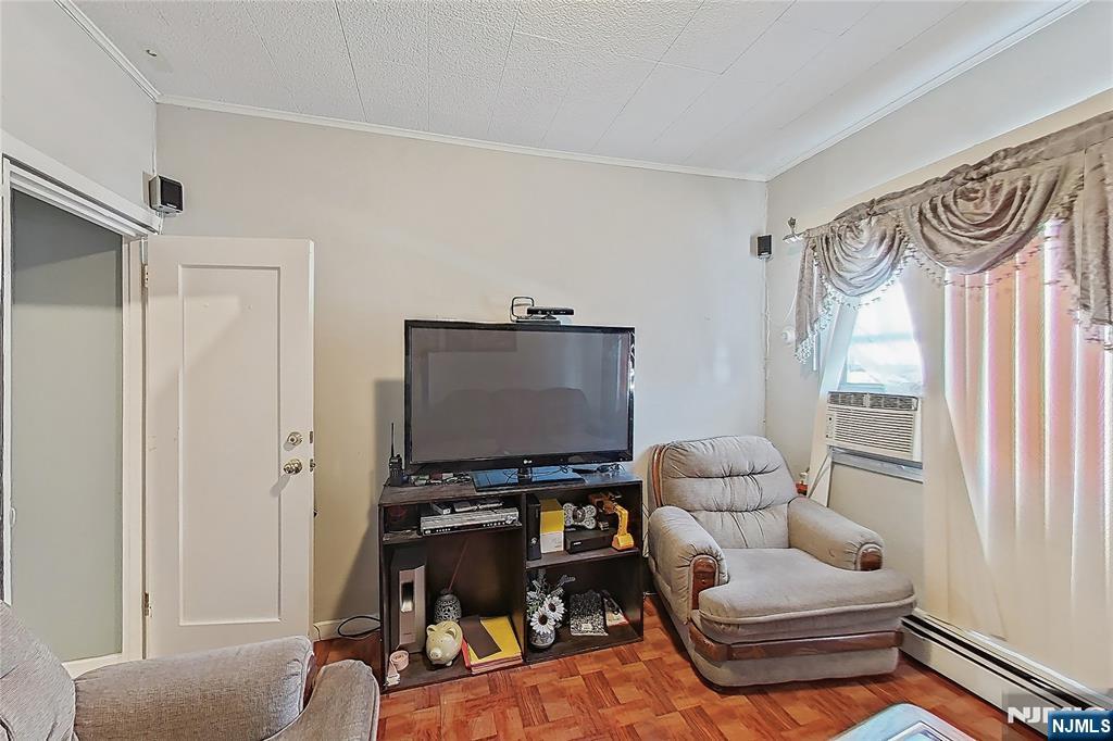 42 Grand Street Garfield, NJ 07026 - Photo 16 of 26 a living room with furniture and a window