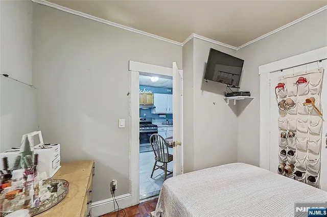 a bedroom with a bed and a television