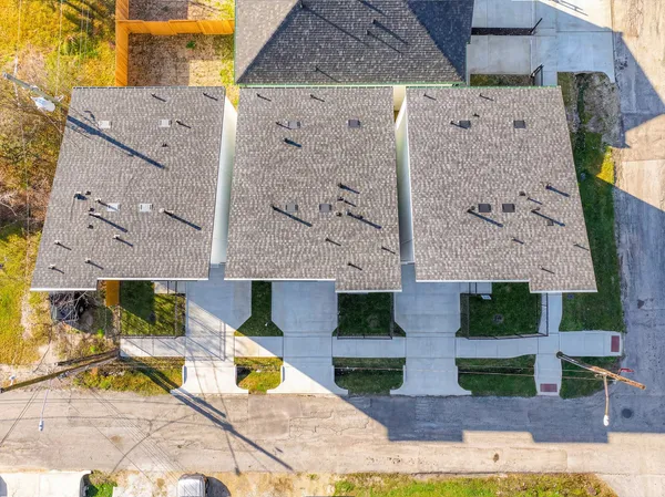 an aerial view of a house with a yard and potted plants