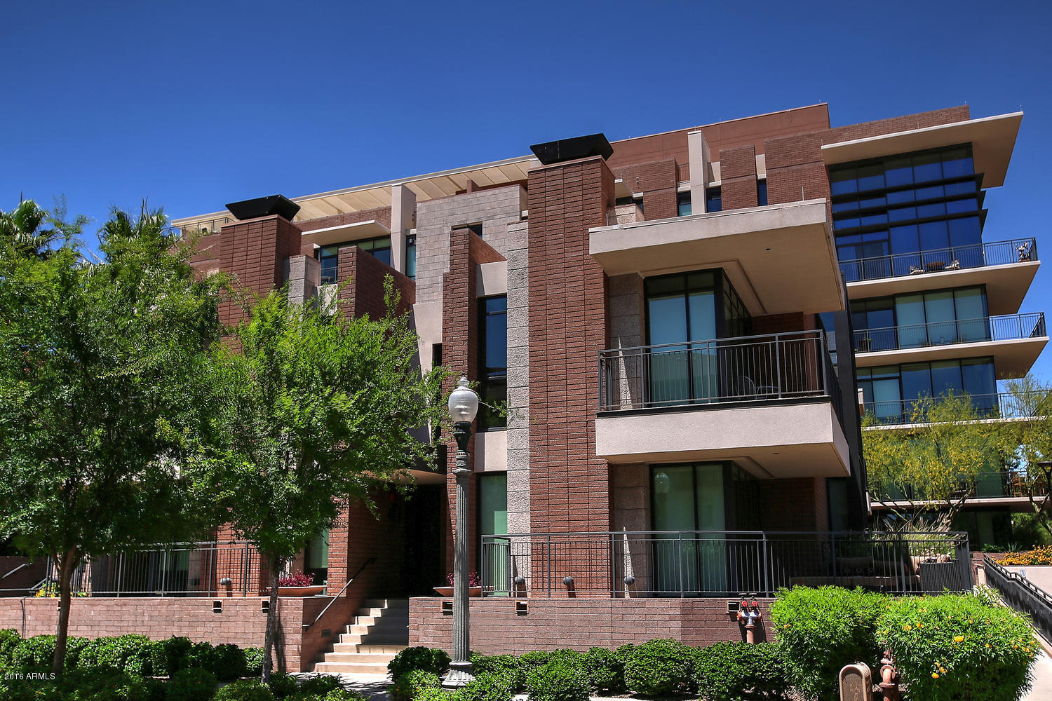 208 West Portland Street, Unit 460 Phoenix, AZ 85003 - Photo 1 of 37 a front view of a building with a garden