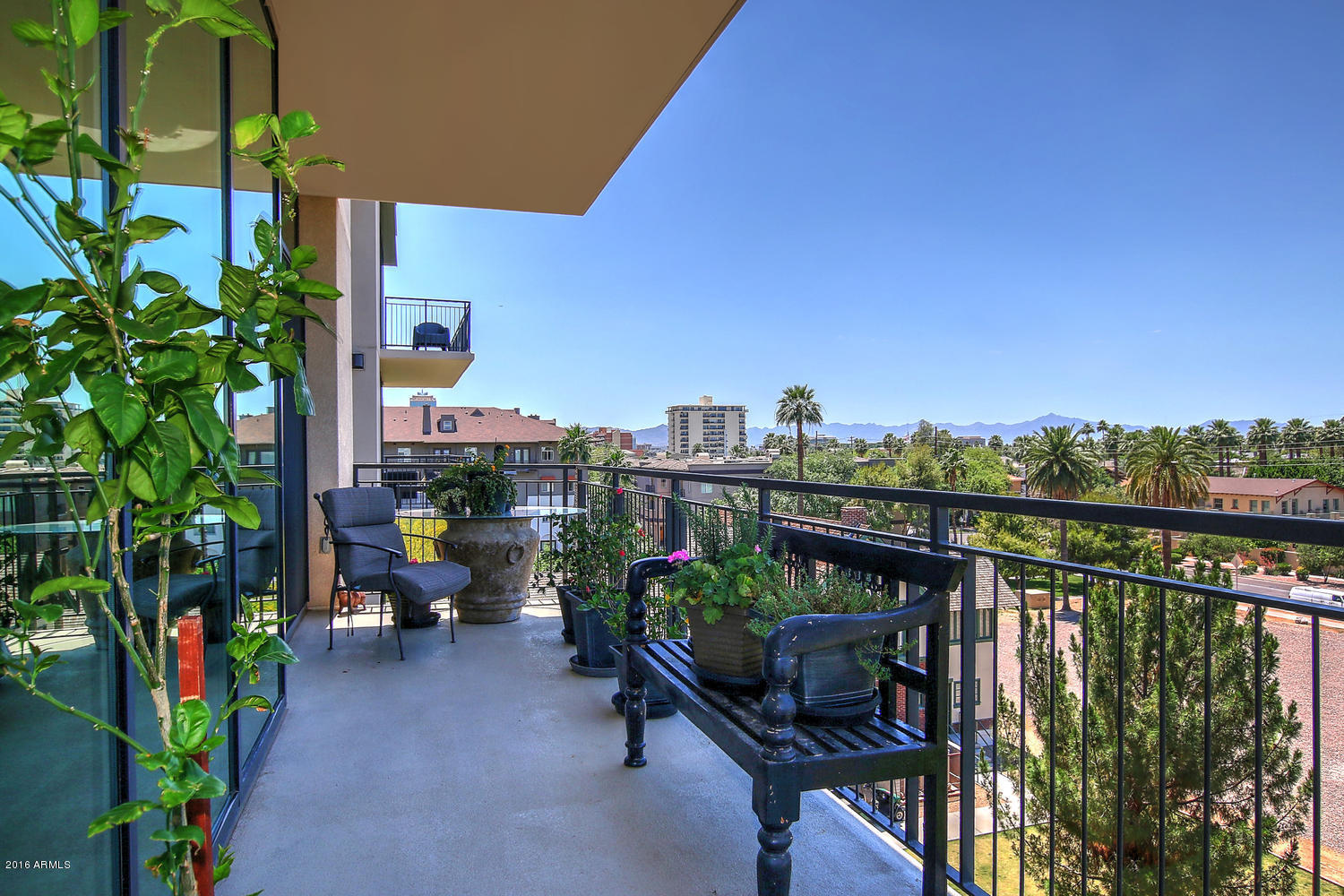 208 West Portland Street, Unit 460 Phoenix, AZ 85003 - Photo 14 of 37 a view of a balcony with chairs and a potted plant