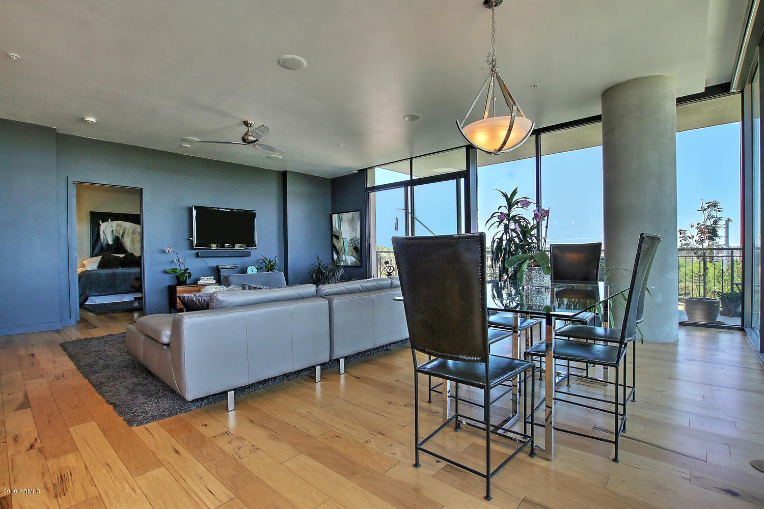 208 West Portland Street, Unit 460 Phoenix, AZ 85003 - Photo 19 of 37 a living room with furniture a window and a flat screen tv