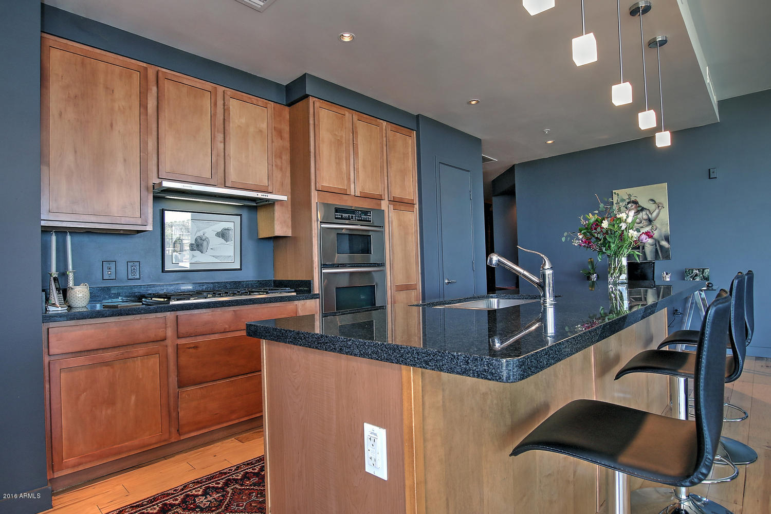 208 West Portland Street, Unit 460 Phoenix, AZ 85003 - Photo 8 of 37 a kitchen with stainless steel appliances granite countertop a sink refrigerator and microwave