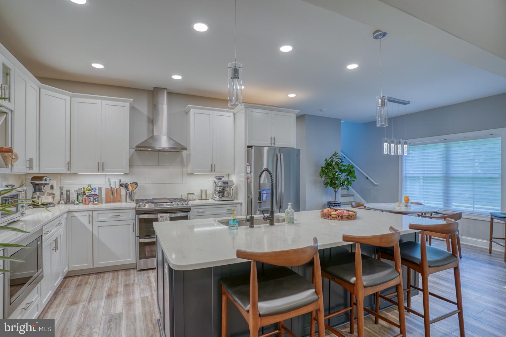 4 Rivers End Drive Seaford, DE 19973 - Photo 9 of 38 a kitchen with a dining table chairs and white cabinets