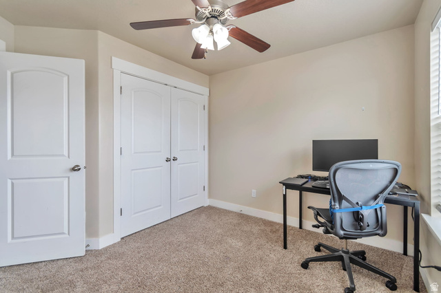13038 Tower Ridge Drive Riverton, UT 84096 - Photo 4 of 30 Carpeted room featuring a ceiling fan with light fixture, white interior doors, and a double-door closet with arched panels