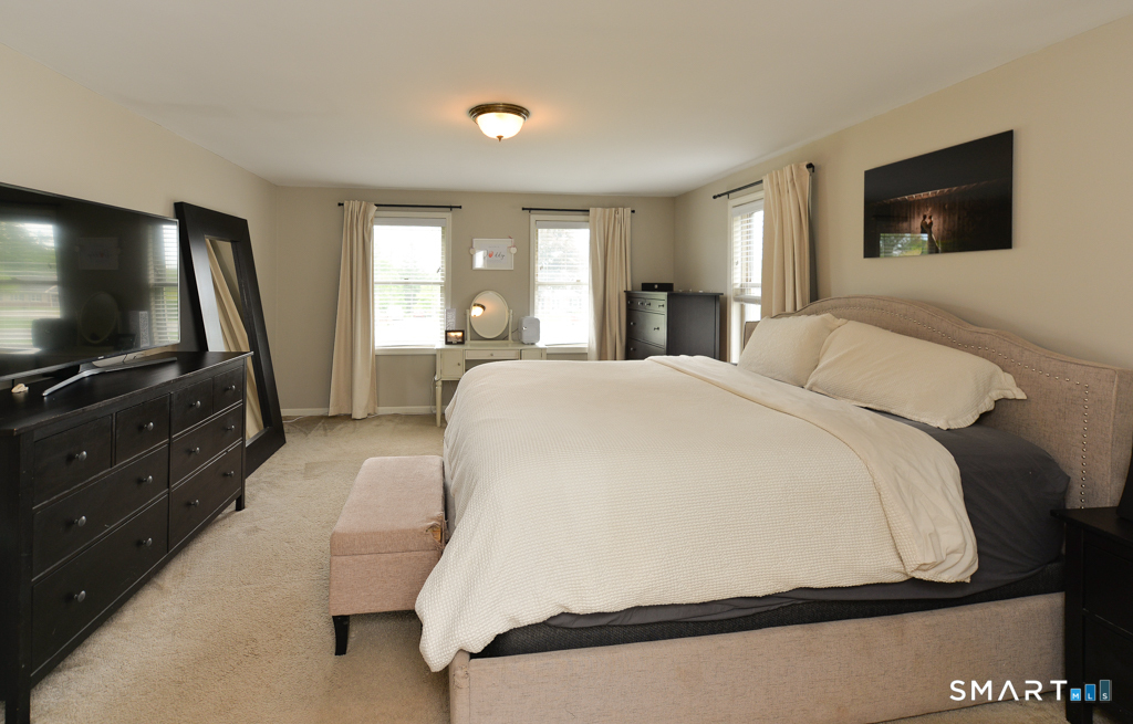109 Harrison Lane Bethlehem, CT 06751 - Photo 17 of 28 a bedroom with a bed and a flat tv screen on dresser