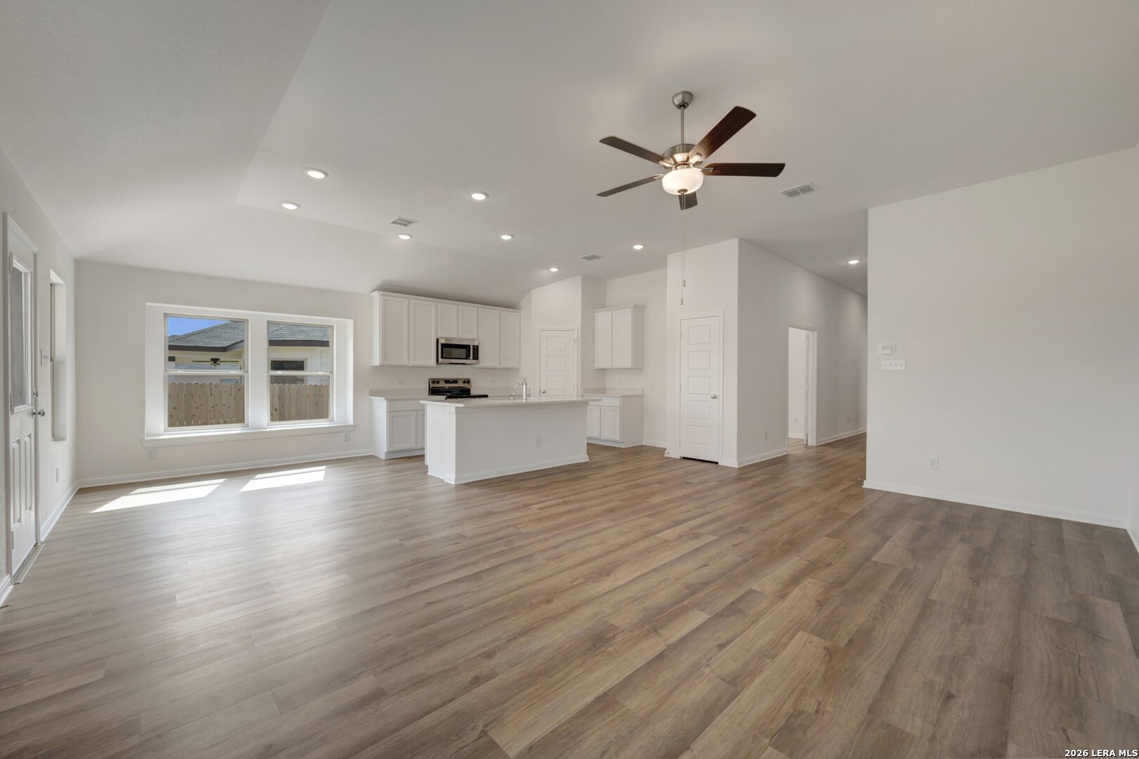 2829 Sun Bayou Seguin, TX 78155 - Photo 11 of 45 a view of an empty room with wooden floor and a kitchen