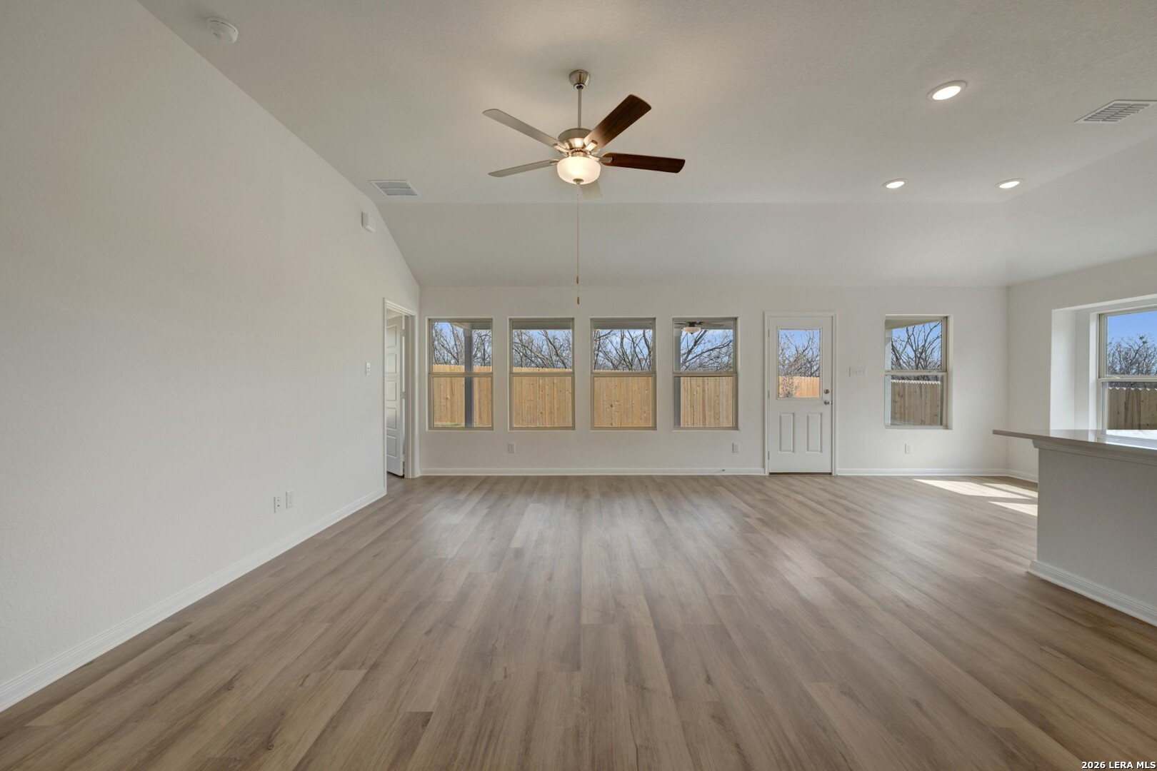 2829 Sun Bayou Seguin, TX 78155 - Photo 13 of 45 a view of an empty room with wooden floor and a window