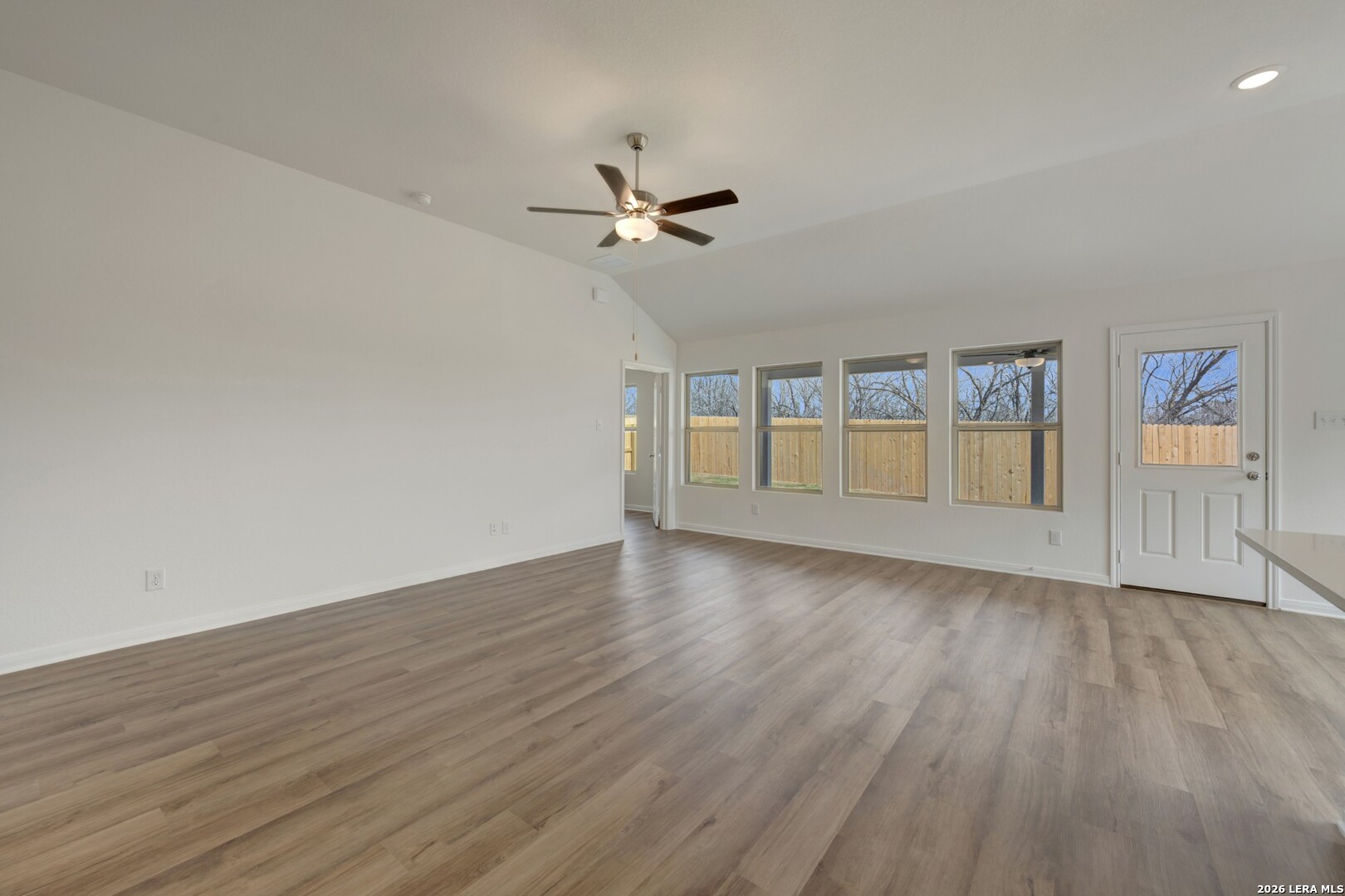 2829 Sun Bayou Seguin, TX 78155 - Photo 14 of 45 an empty room with wooden floor ceiling fan and windows