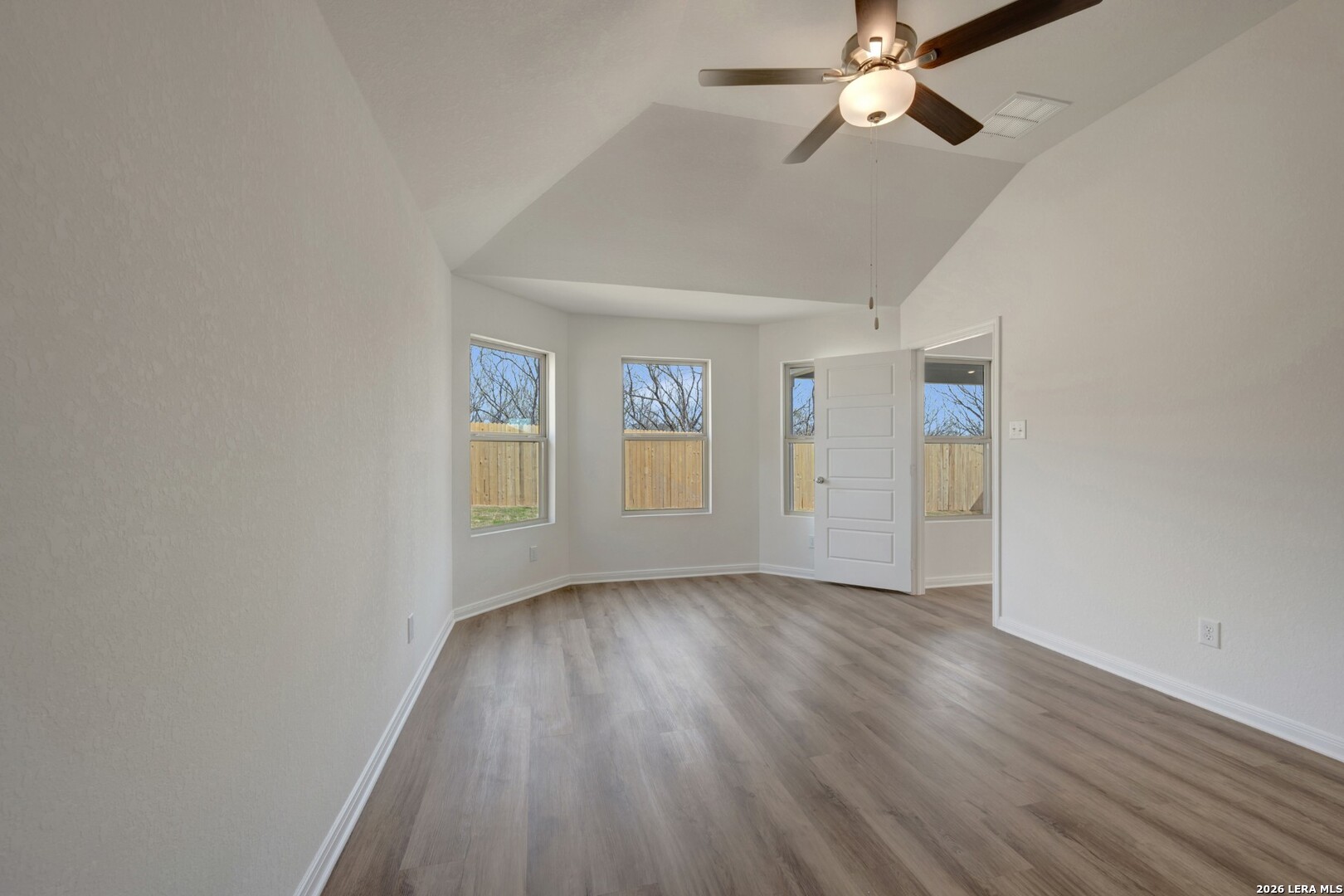 2829 Sun Bayou Seguin, TX 78155 - Photo 18 of 45 an empty room with wooden floor chandelier fan and windows