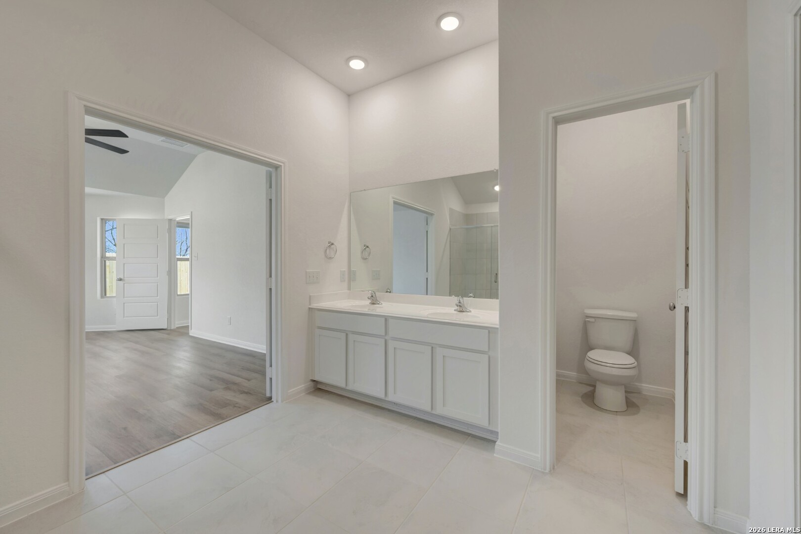 2829 Sun Bayou Seguin, TX 78155 - Photo 25 of 45 a bathroom with a granite countertop toilet a sink and a mirror