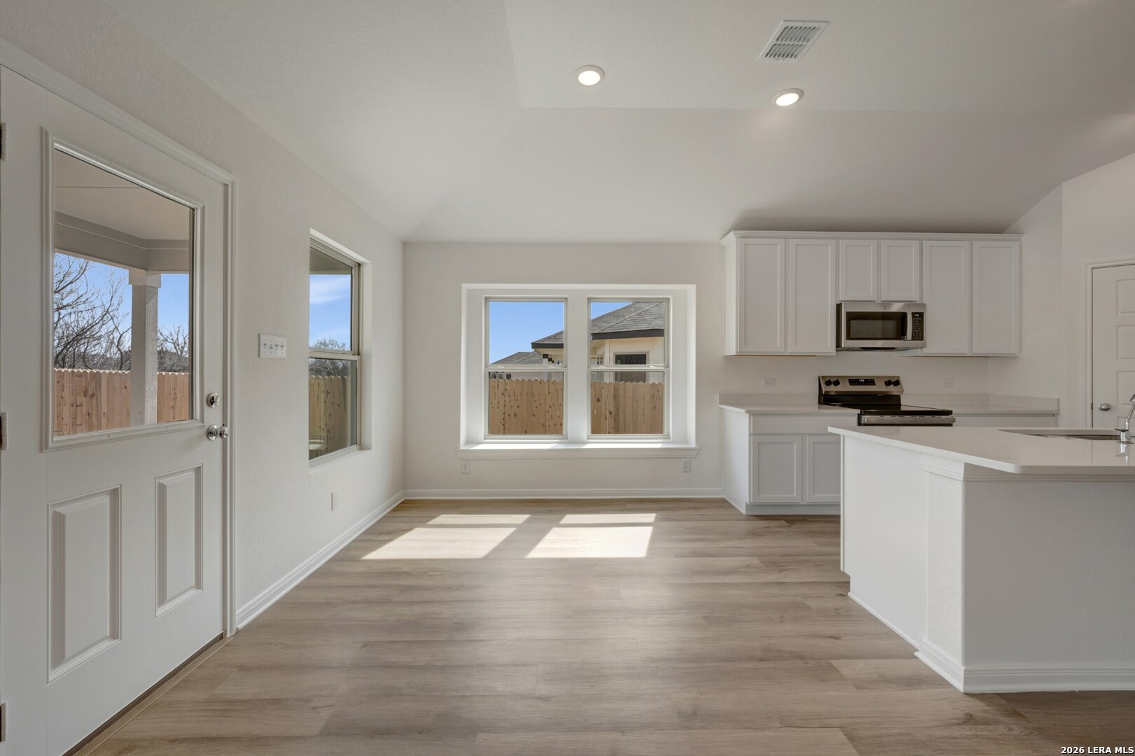 2829 Sun Bayou Seguin, TX 78155 - Photo 5 of 45 a kitchen with granite countertop a stove a sink and a refrigerator