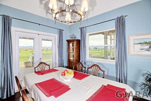 2050 J J 1/2 Road Fruita, CO 81521 - Photo 8 of 9 a view of a dining room with furniture a chandelier and a window