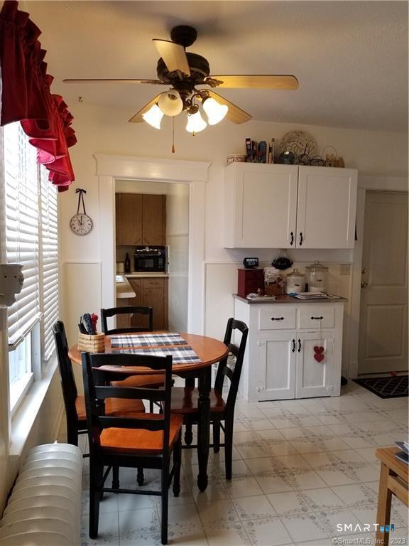 26 4th Street Hamden, CT 06514 - Photo 10 of 40 a kitchen with a dining table and chairs