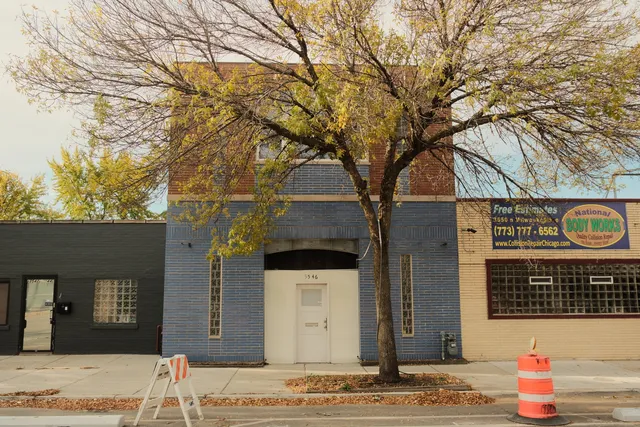 a view of a brick house with large windows and refrigerator