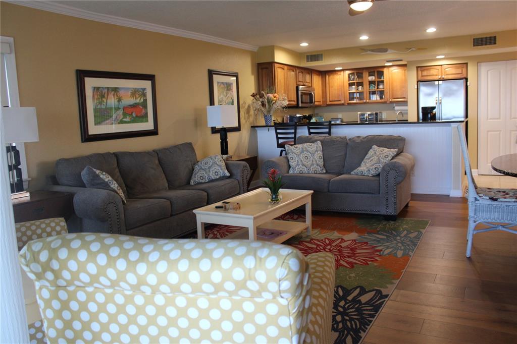 335 Windrush Loop, Unit 335 Tarpon Springs, FL 34689 - Photo 3 of 18 a living room with furniture and a view of kitchen