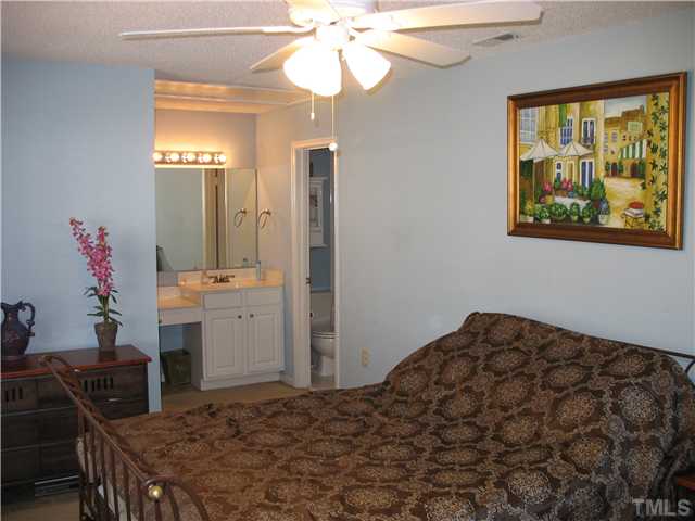 2406 Condor Court Raleigh, NC 27615 - Photo 11 of 16 a bedroom with a bed and a table