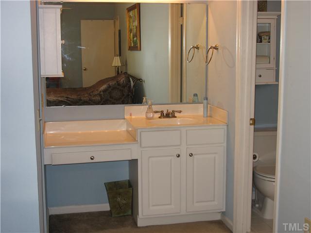 2406 Condor Court Raleigh, NC 27615 - Photo 12 of 16 a bathroom with a sink and a mirror