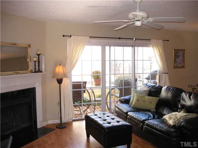 2406 Condor Court Raleigh, NC 27615 - Photo 4 of 16 a living room with furniture and a fireplace
