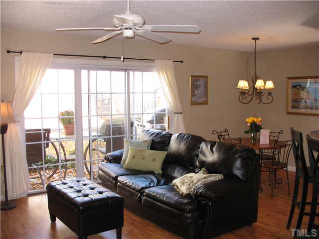 2406 Condor Court Raleigh, NC 27615 - Photo 16 of 16 a living room with furniture chandelier and a flat screen tv