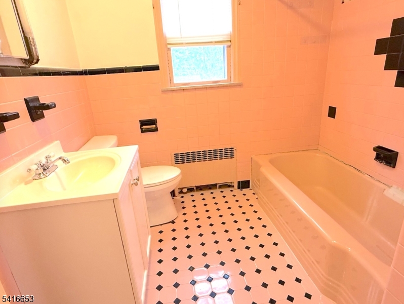 34 Howard Street Verona, NJ 07044 - Photo 11 of 20 a bathroom with a sink a toilet and a shower