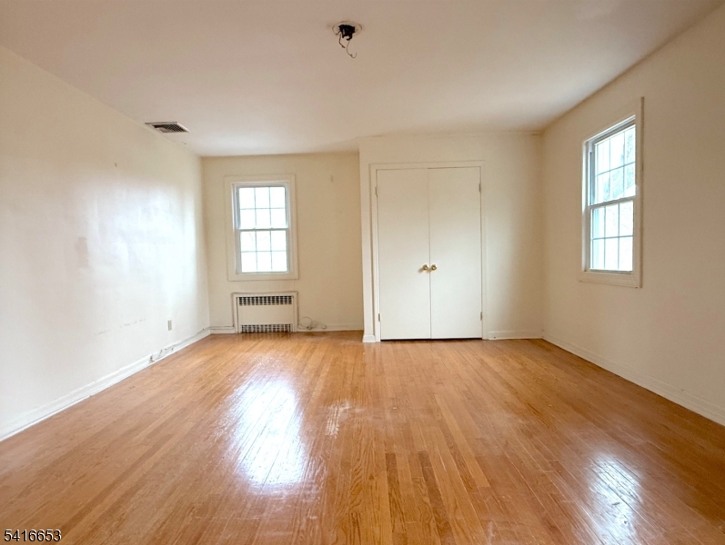 34 Howard Street Verona, NJ 07044 - Photo 17 of 20 an empty room with wooden floor and windows