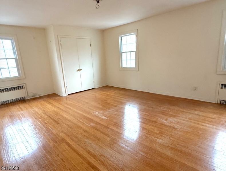34 Howard Street Verona, NJ 07044 - Photo 18 of 20 an empty room with wooden floor and windows