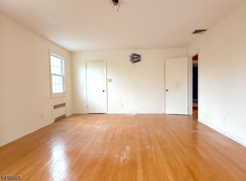 34 Howard Street Verona, NJ 07044 - Photo 19 of 20 a view of an empty room with wooden floor and window