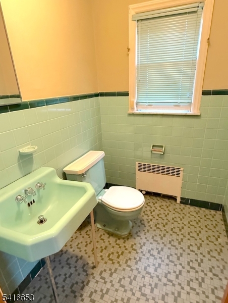 34 Howard Street Verona, NJ 07044 - Photo 20 of 20 a bathroom with a sink a toilet and a mirror