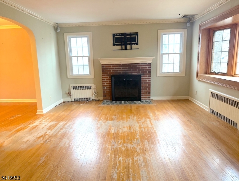 34 Howard Street Verona, NJ 07044 - Photo 5 of 20 an empty room with windows and a fireplace