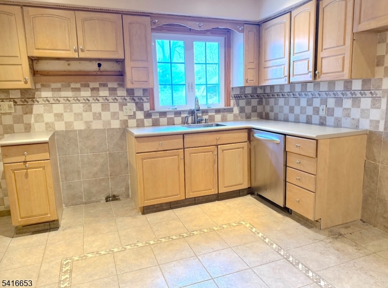 34 Howard Street Verona, NJ 07044 - Photo 7 of 20 a kitchen with granite countertop a sink window and cabinets