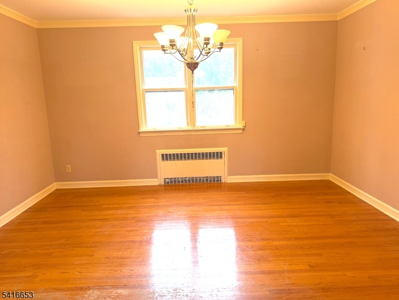 34 Howard Street Verona, NJ 07044 - Photo 9 of 20 a view of an empty room with wooden floor and a window