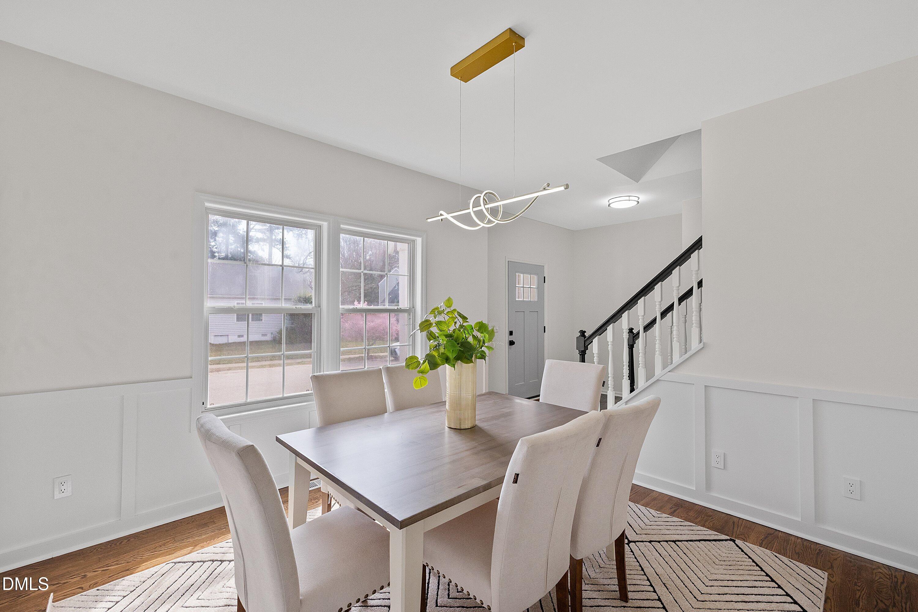 4219 Mantua Way Raleigh, NC 27604 - Photo 16 of 44 a view of a dining room with furniture and a potted plant