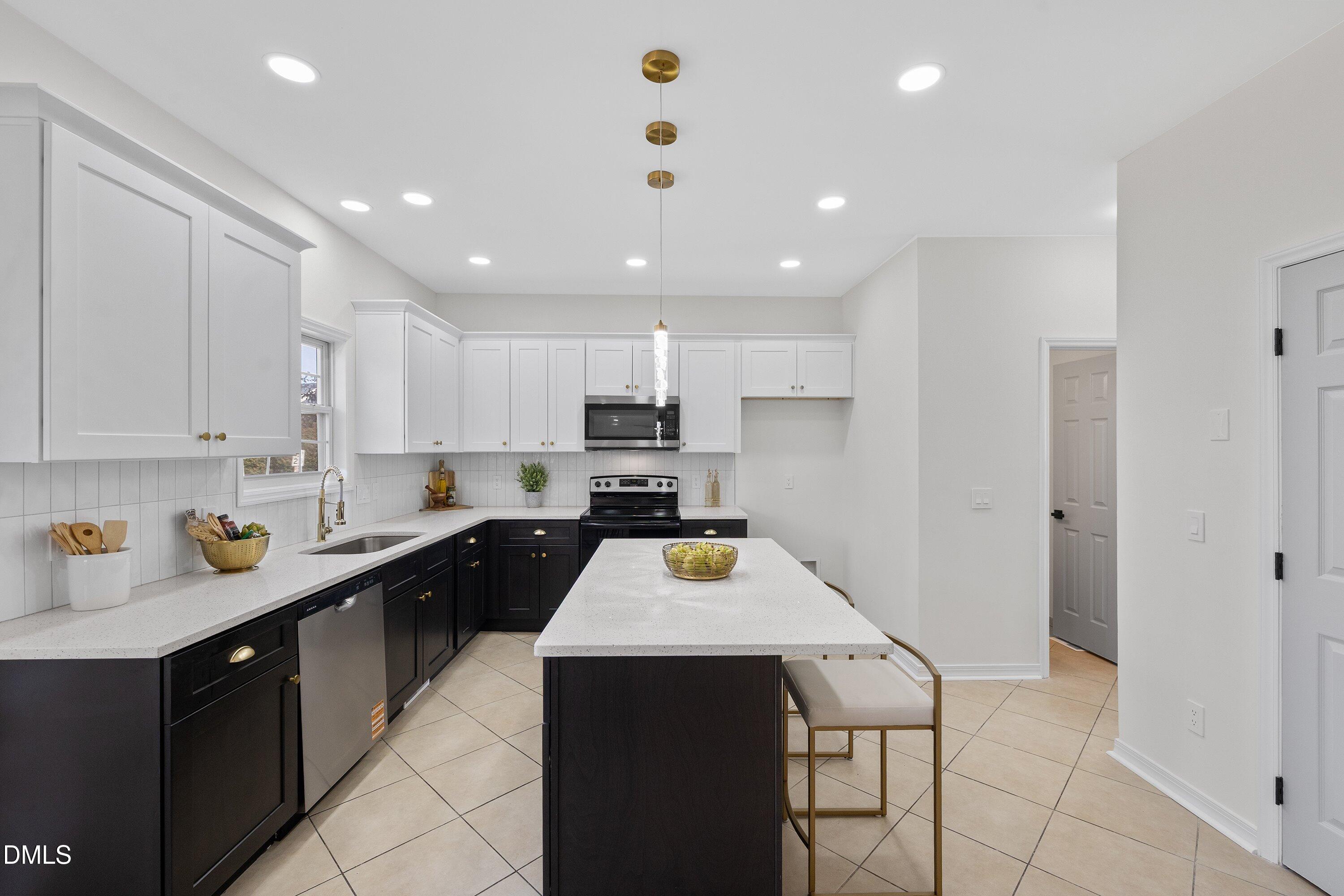 4219 Mantua Way Raleigh, NC 27604 - Photo 2 of 44 a kitchen with a sink a counter top space and stainless steel appliances