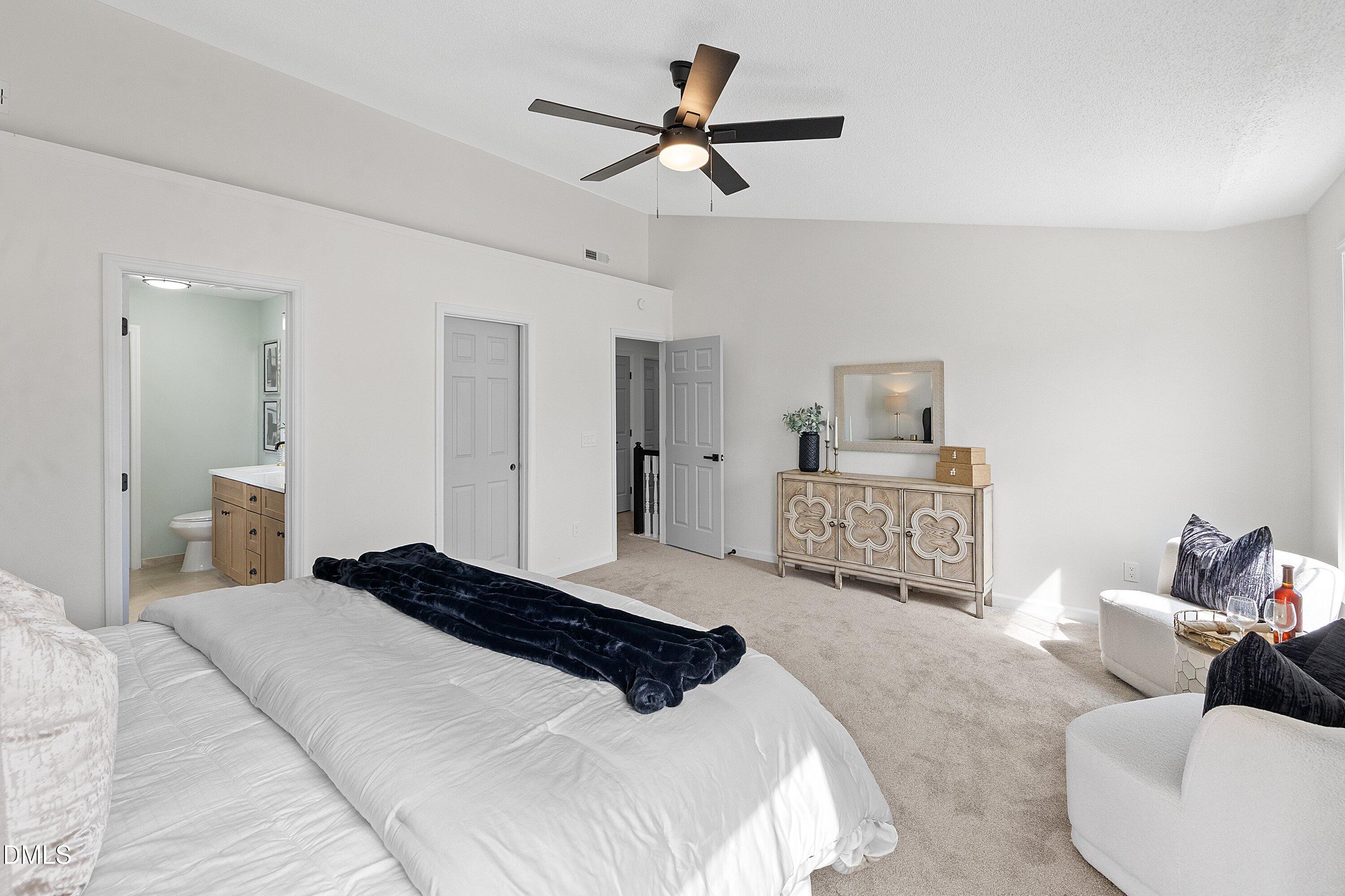 4219 Mantua Way Raleigh, NC 27604 - Photo 24 of 44 a bedroom with a bed couches and white walls