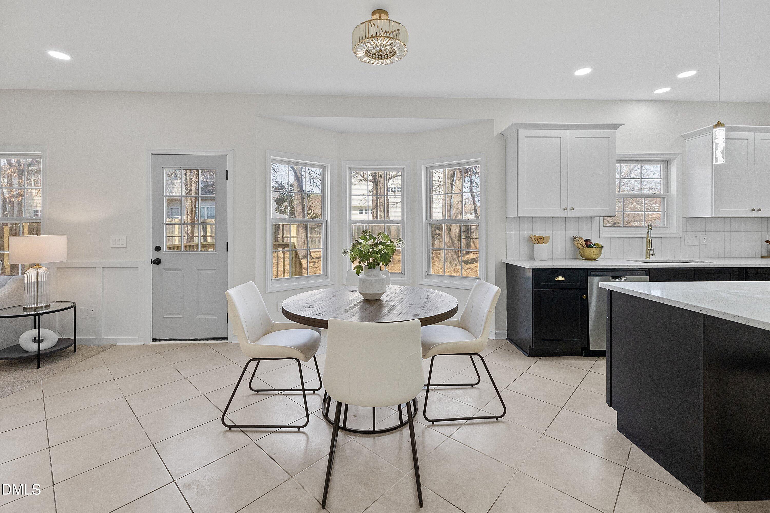 4219 Mantua Way Raleigh, NC 27604 - Photo 3 of 44 a view of a dining room with furniture and a chandelier