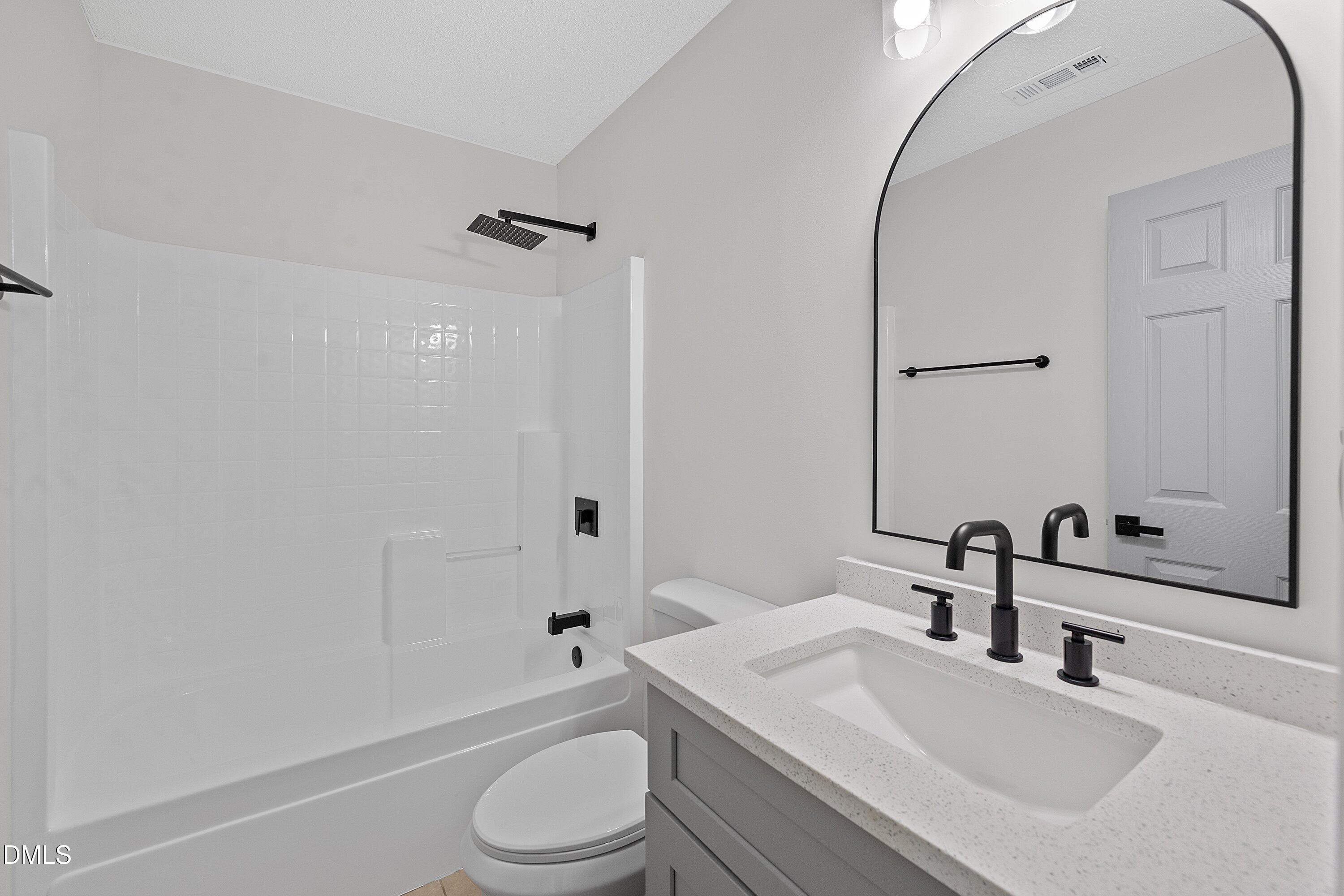 4219 Mantua Way Raleigh, NC 27604 - Photo 33 of 44 a bathroom with a sink toilet vanity and shower