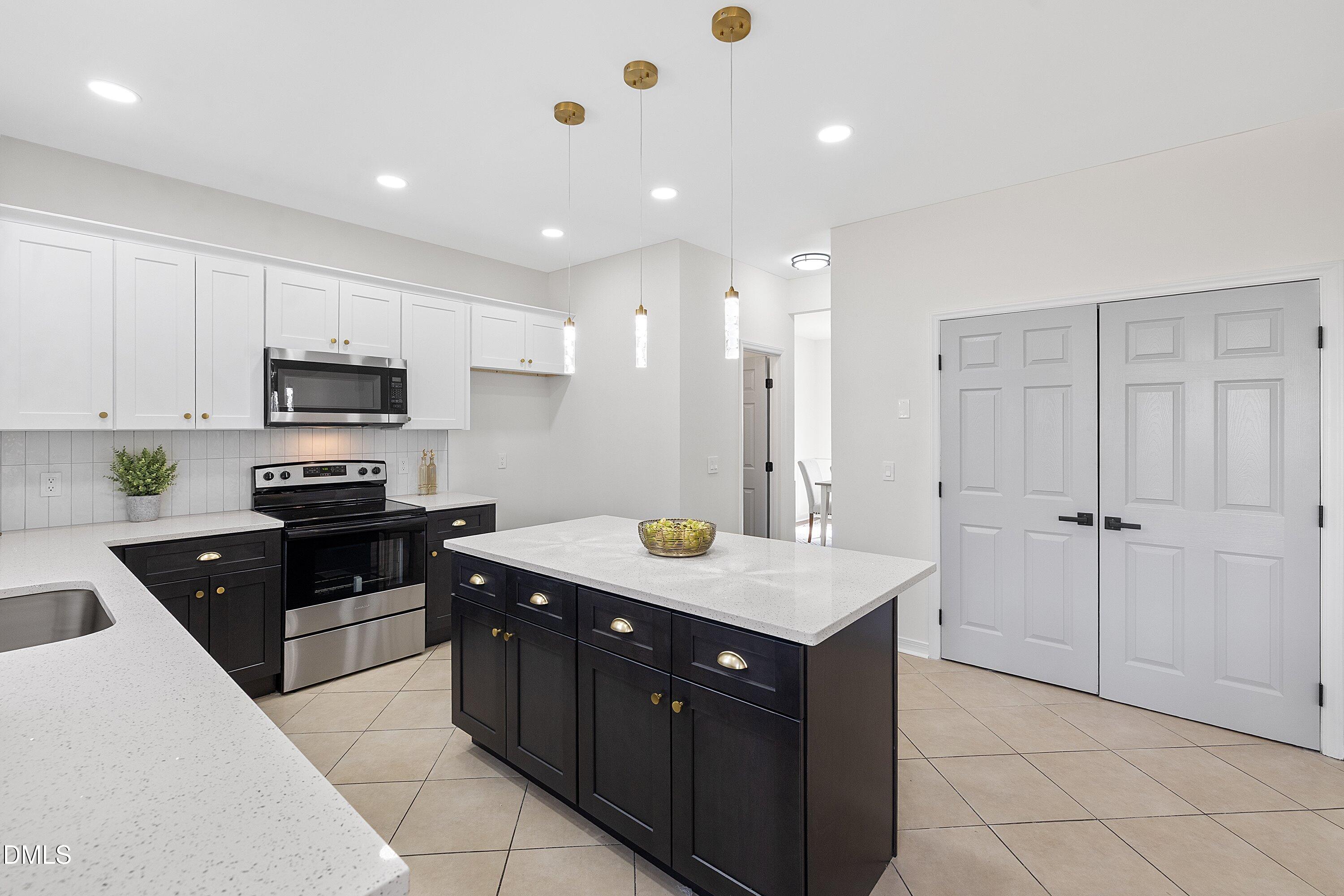 4219 Mantua Way Raleigh, NC 27604 - Photo 9 of 44 a kitchen with a sink stove and microwave